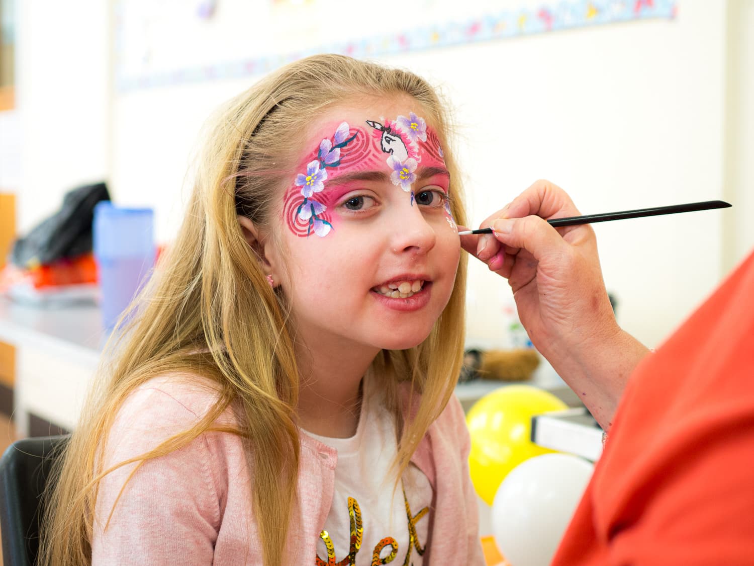 A child having their face painted