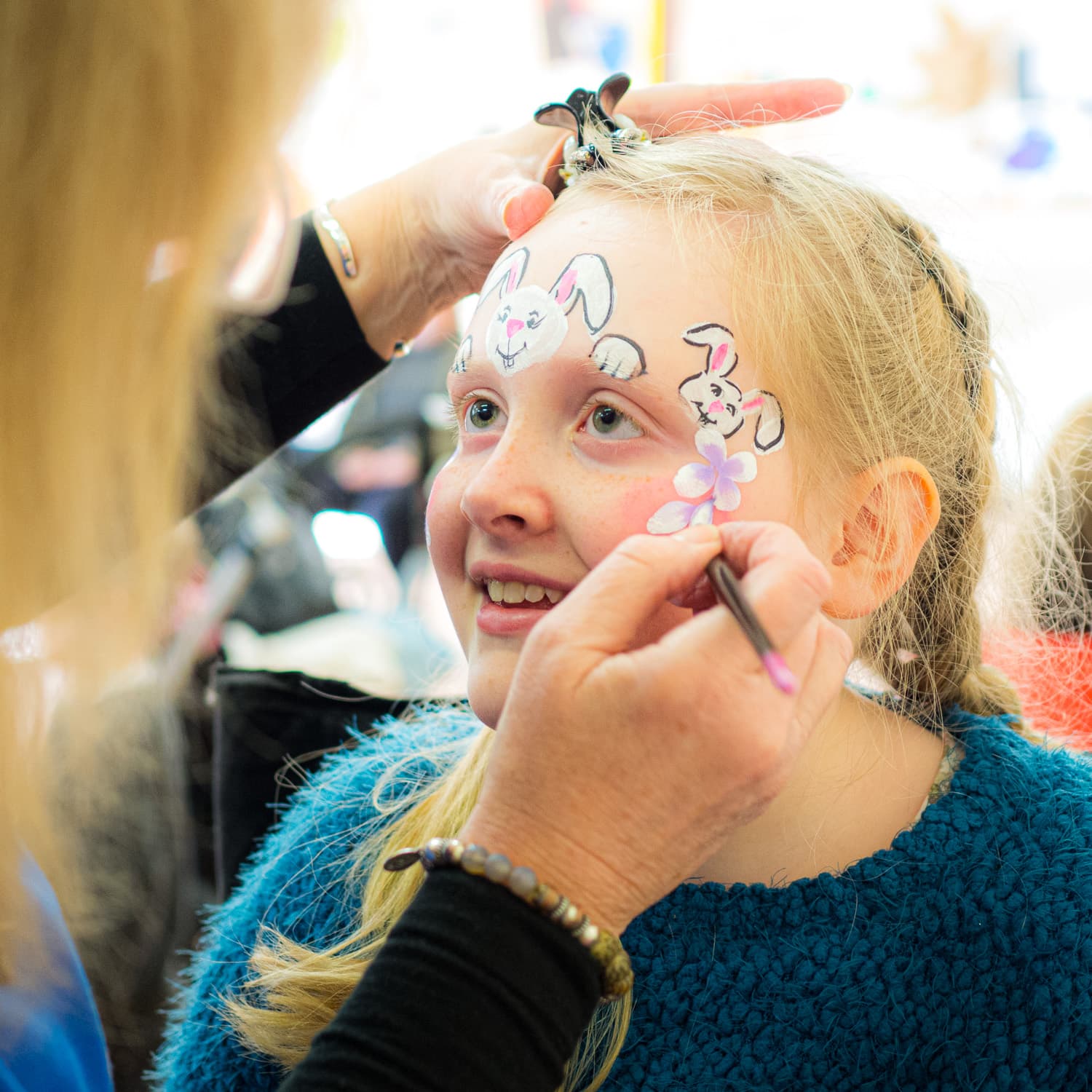 A child getting an Easter design painted on their face