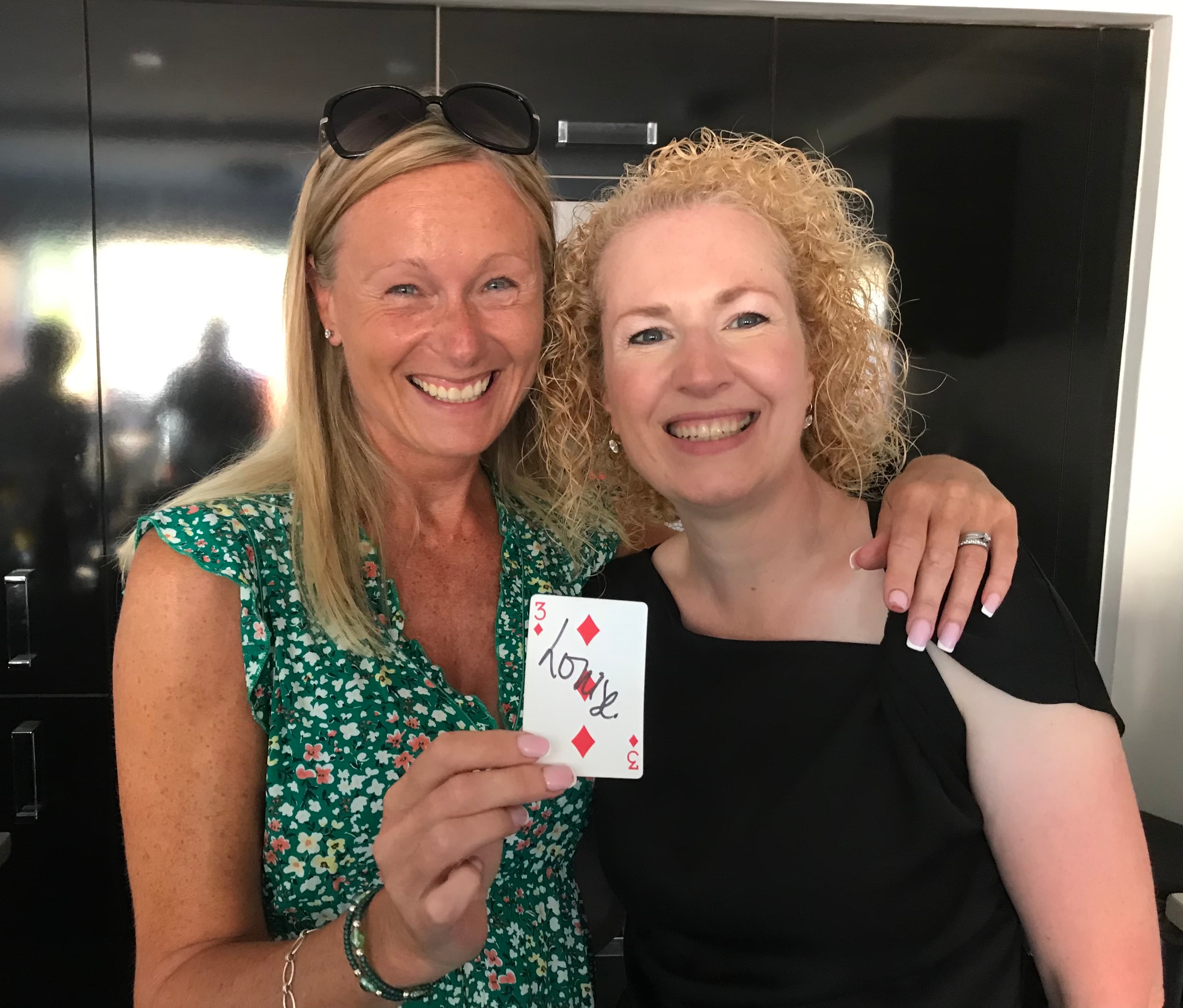 Two people holding the card they signed
