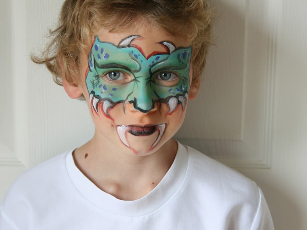 A child wearing monster face paint