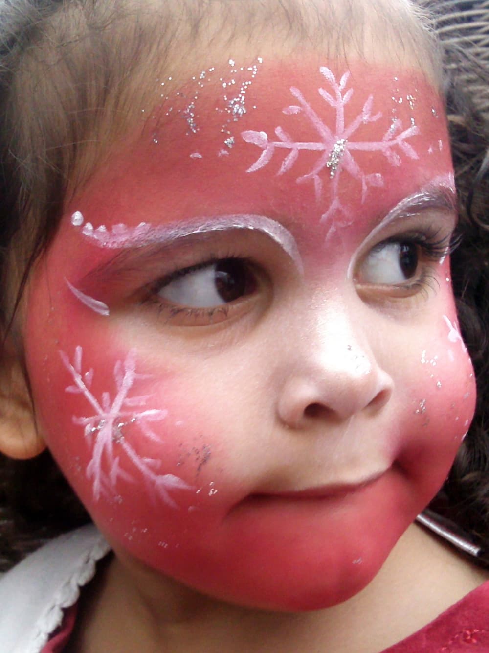 A child with red face paint