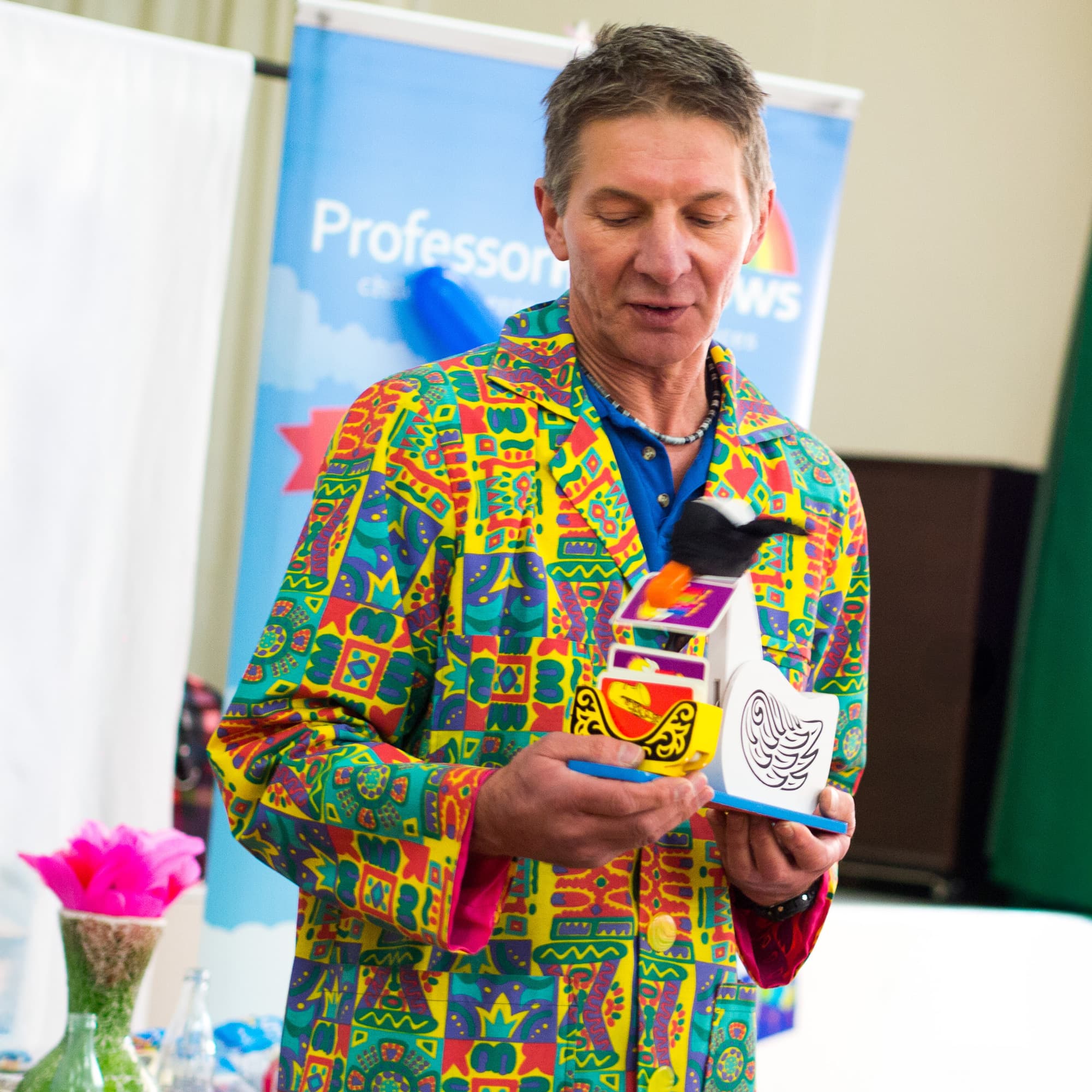 A magician with a blindfolded duck