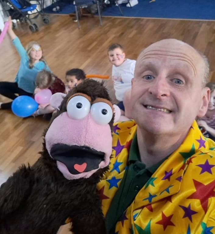 Childrenās entertainer with a monkey puppet